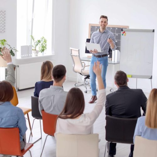 Male business trainer giving lecture in office